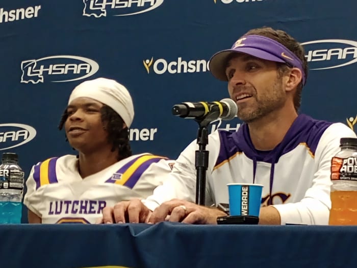 Lutcher CB Craydon Long, left, and coach Dwain Jenkins discuss the Bulldogs' 28-25 win against North DeSoto for the Division II non-select championship on Dec. 10, 2022.